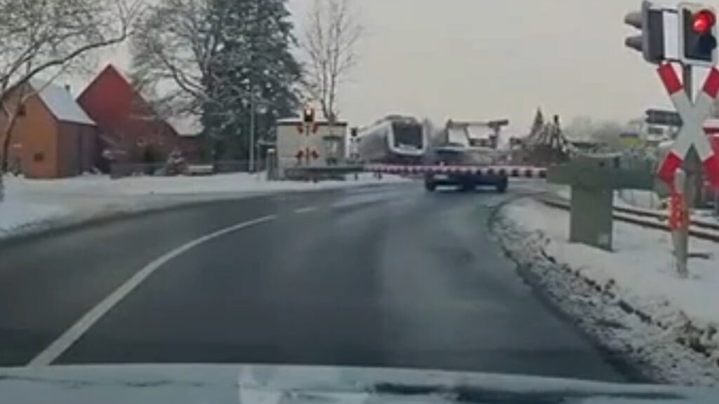 Video frame showing a damaged car on a railway crossing after being struck by a regional train in Eisbergen, Germany.