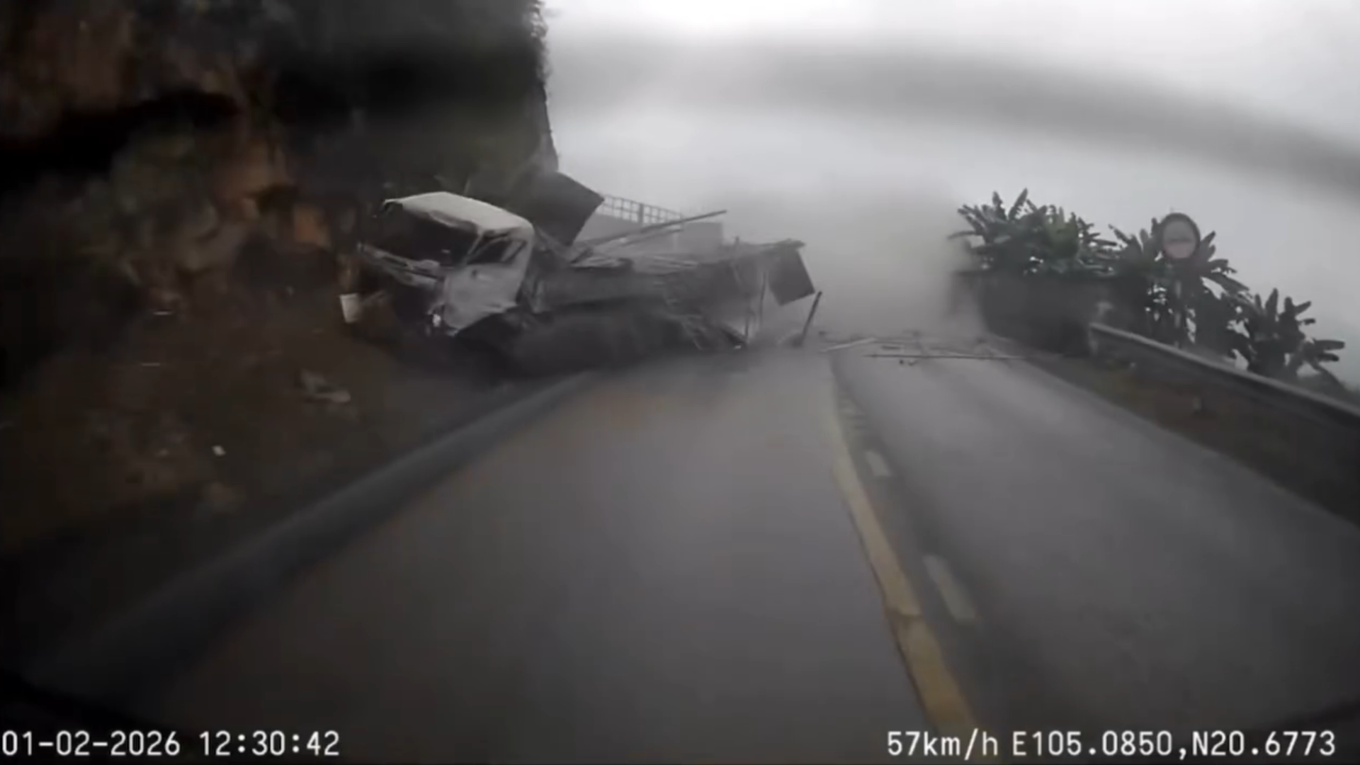 A wide frame from the video showing the truck skidding near the guardrail on the mountain pass.